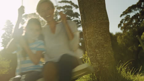 mother and daughter on a swing