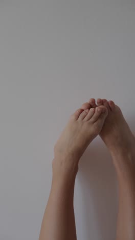 Bare Feet Against Light Gray Wall