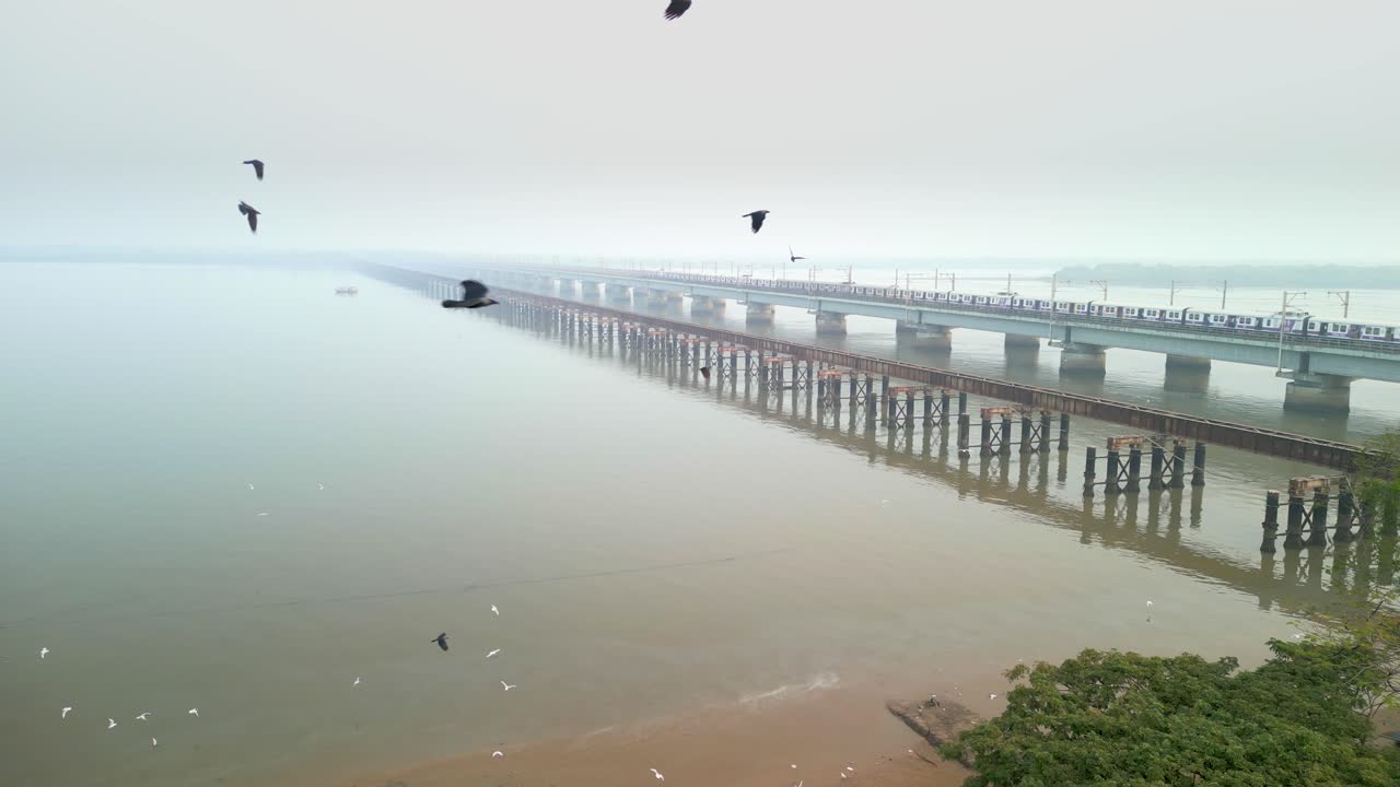 train going from bhayandar staton on vasai creek bridge wide bird eye view