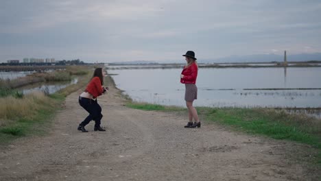 photographer shooting a model in a countryside setting