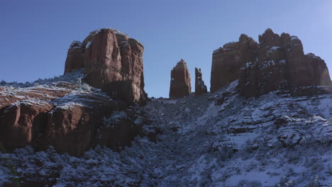 Aerial-Pan-4-of-Cathedral-Rock-near-Oak-Creek,-Sedona-Arizona---After-a-snowfall