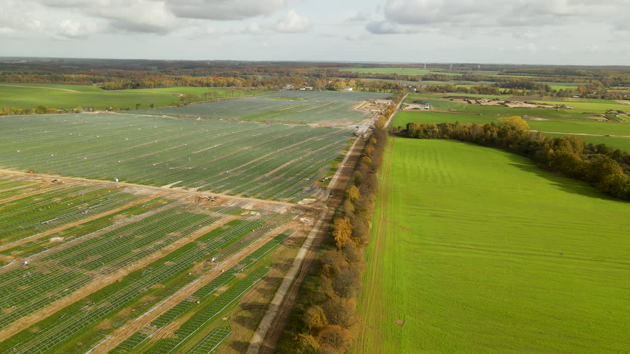 Construction Site Of The Largest in Poland Solar Energy Park Near Zwartowo, Poland in Autumn - Aerial Wide Shot