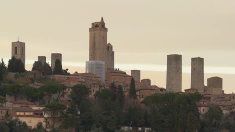 time lapse behind the beautiful town of san gimignano in italy with shadows rising