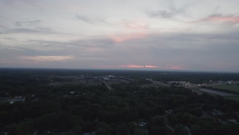 Aerial-drone-forward-moving-shot-over-a-lumber-mill-at-sunset