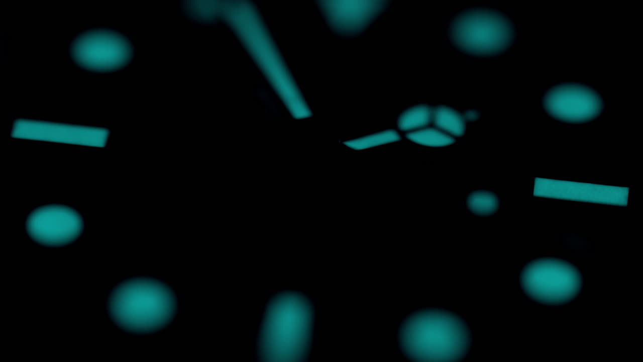 Close-up of a watch ticking in dim light