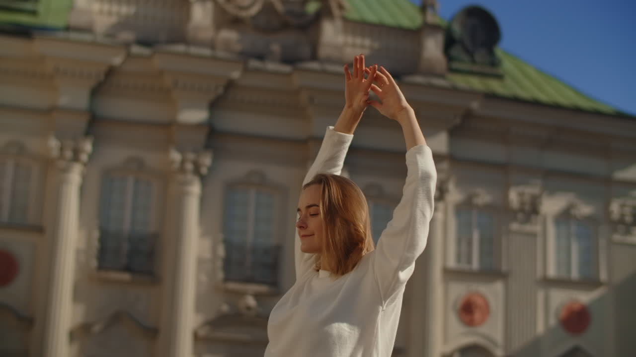 Woman enjoying a sunny day in front of a palace