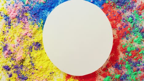 video of multi coloured powders and white circle with copy space on white background