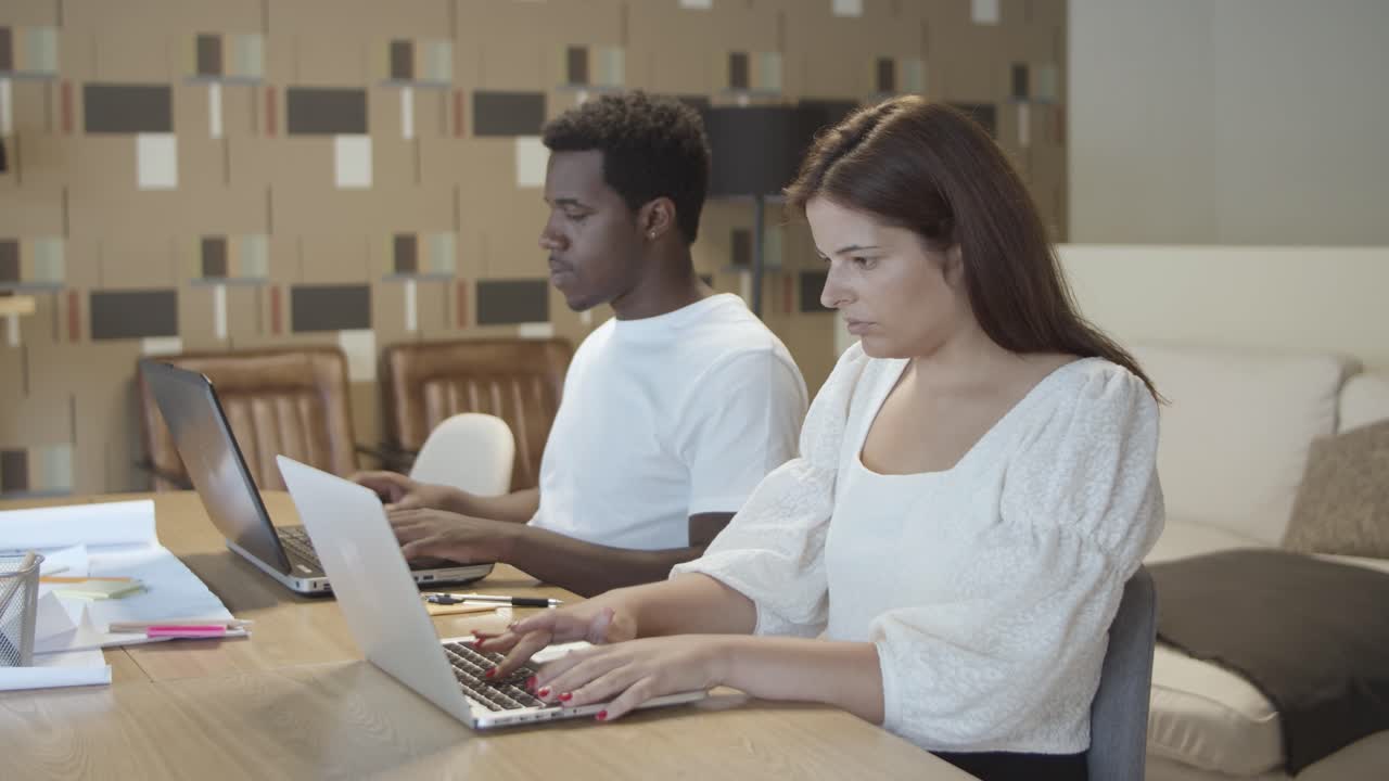 Two coworkers sitting together at table