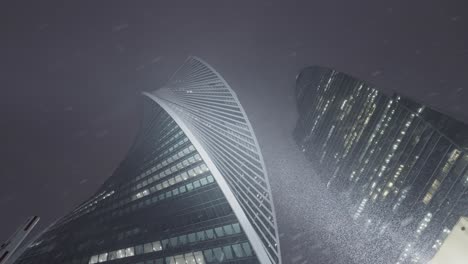 rascacielos modernos en moscú durante una tormenta de nieve por la noche