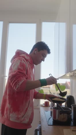 young adult cooking at home