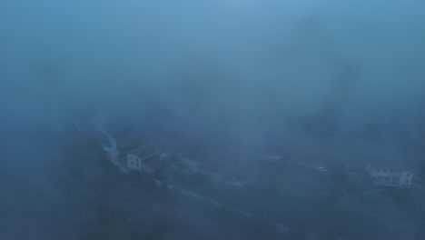 early morning fog blankets the sleepy town of nanclares de gamboa, basque country, creating a serene atmosphere