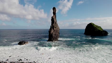 aerial ascent of photographer walking to take picture of coastal rock formation, madiera, portugal