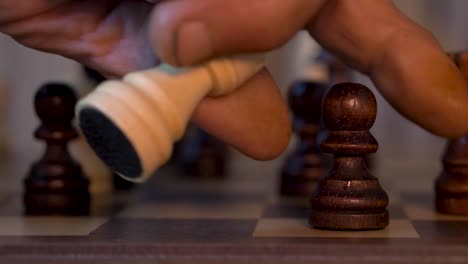 white bishop takes pawn in chess match - close up shot