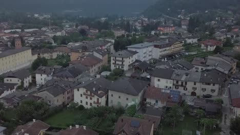 aerial reveal type clip of levico terme, italy, during sunrise