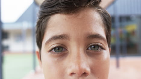 In-a-school-playground,-a-close-up-of-a-young-Caucasian-student