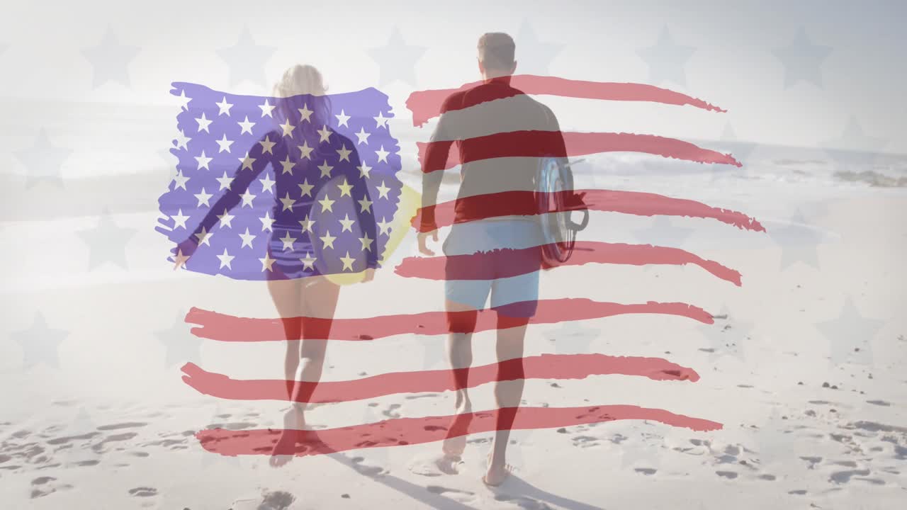 estrellas múltiples y bandera estadounidense ondeando contra una pareja con tablas de surf corriendo en la playa
