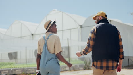 two people discussing work at a greenhouse