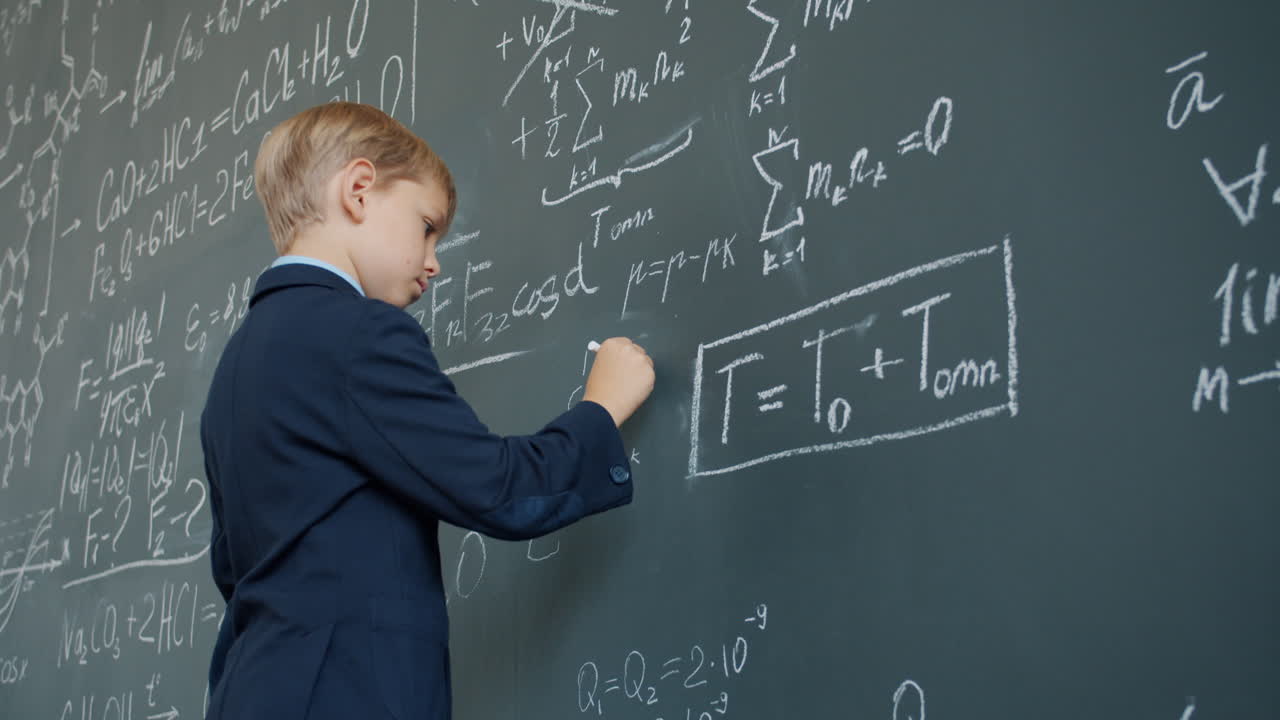 Young Boy Solving Math Problem on Chalkboard