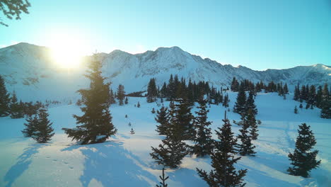 Cinematic-blue-dramatic-stunning-Colorado-early-morning-shaded-Rocky-Mountain-top-of-peaks-sun-glare-backcountry-skier-snowboarder-fresh-snow-winter-Copper-Breckenridge-Aspen-Vail-pan-left-movement