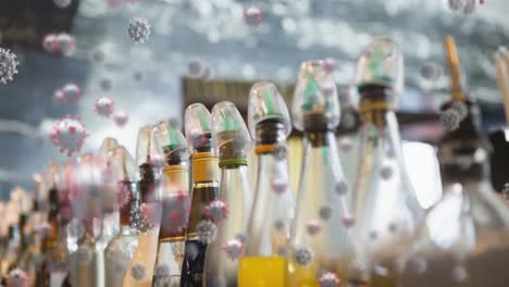 múltiples iconos de células de covid-19 flotando contra coloridas botellas de vidrio de jarabe en el fondo