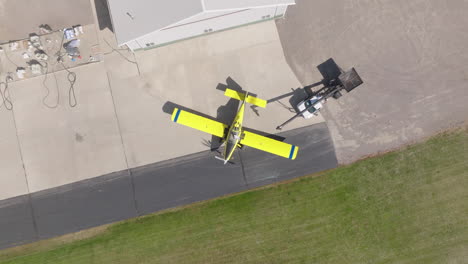 Aerial-View-of-Crop-Duster-Plane-Being-Loaded-with-Seed-and-Truck-Backing-Away