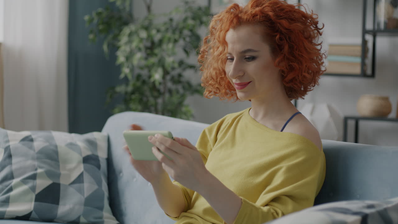 mujer usando teléfono inteligente en el sofá