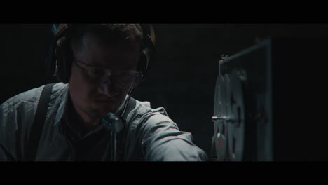 an intelligence officer listens to the wiretap recordings