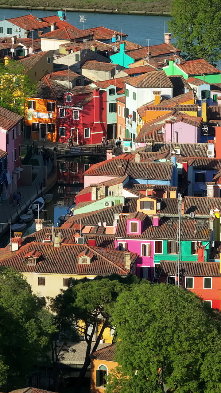 Aerial drone view of the colourful houses of Burano Island, Italy. Vertical