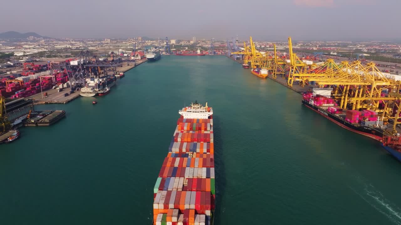 Aerial shot of container ship leaving dock, Thailand