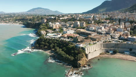 spiaggia di castellammare park with punta petrolo in castellammare del golfo town in sicily, italy