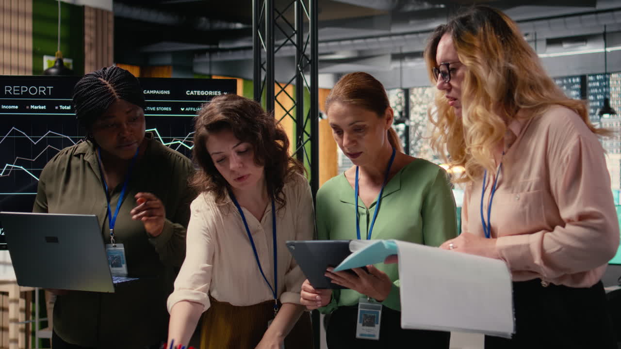 Vertical Video Strong diverse team of women works together on project analysis