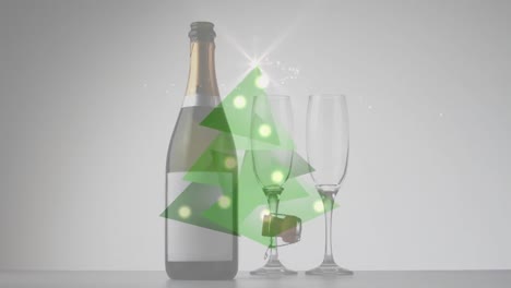 video compuesto digital del árbol de navidad hecho de triángulos verdes contra una botella de champán