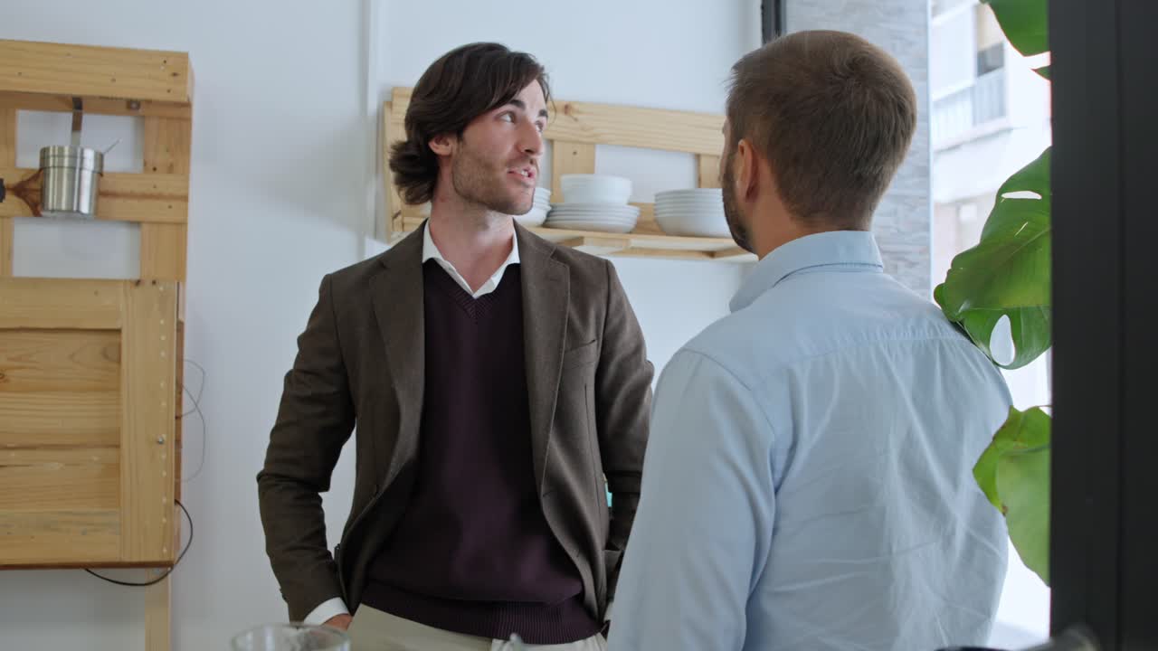 Men having a conversation indoors