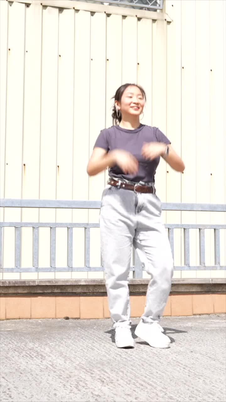 Woman dancing in jeans and t-shirt