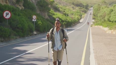 sporty mixed race man with prosthetic leg hiking