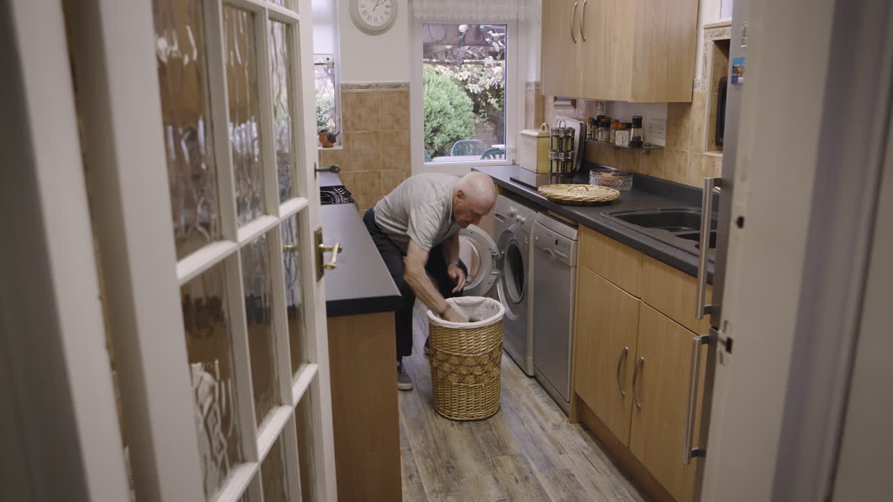 A person doing laundry in a kitchen