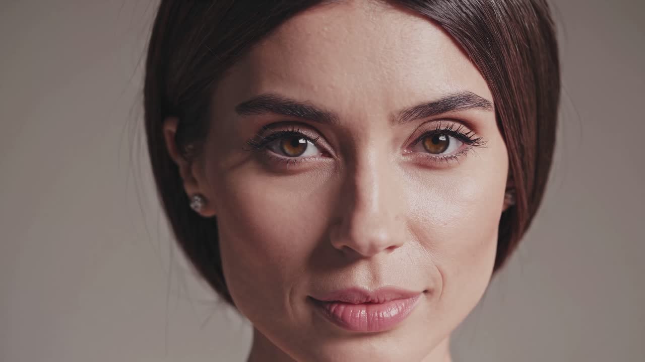 Close-up video portrait of a woman with a neutral expression