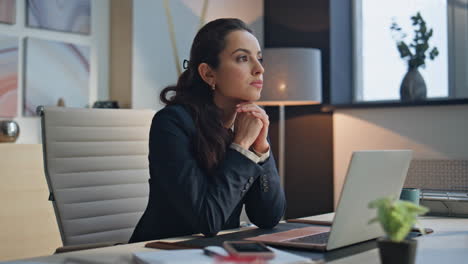 pensive businesswoman resting desk at workplace. woman taking break thinking