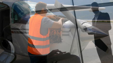 inspecting aircraft engine, maintenance worker with business professional overlay animation