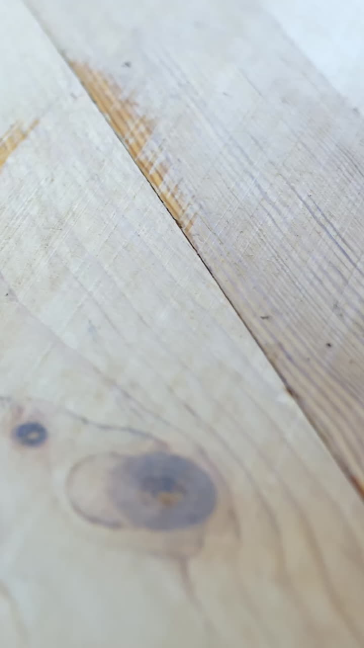 Vertical close-up shows a freshly sanded wooden floor with a clean, smooth finish.