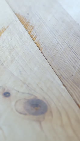 vertical close-up shows a freshly sanded wooden floor with a clean, smooth finish.