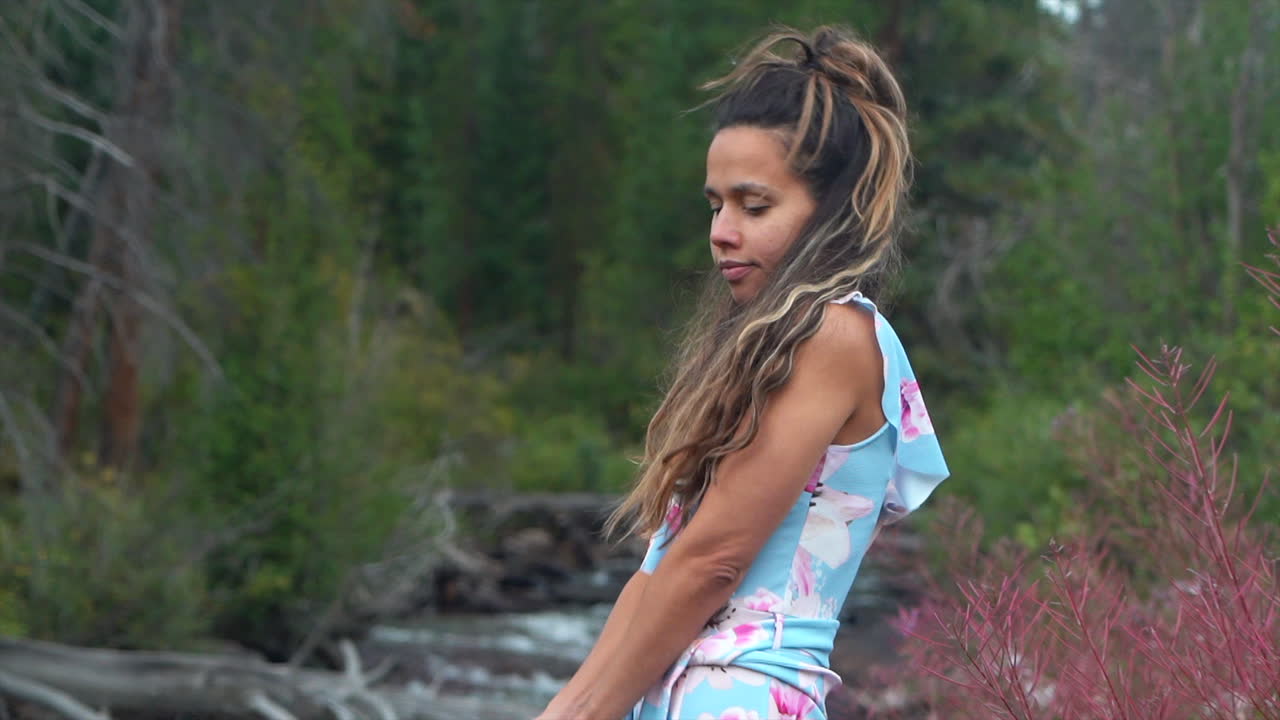 Cinematic female women actress model close up standing on rocks towards still calm Piney River Ranch Denver Vail Beaver Creek Avon Gore range scenic mountain landscape gold hour light adventure