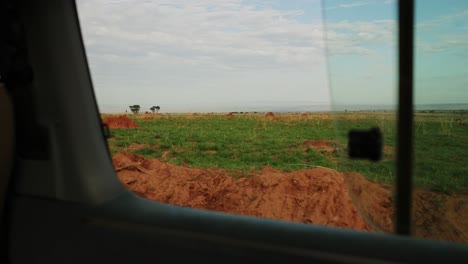 Shot-out-of-window-of-African-plains-passing-by-on-safari