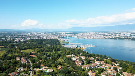 dolly out drone shot of rade and water fountain of geneva during the day from cologny, switzerland