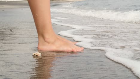 waves breaking on ladies feet