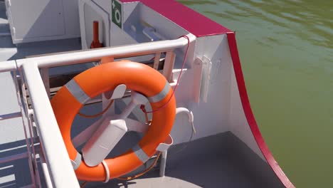 lifebelt of lifebuoy on side of boat driving over water - close up shot