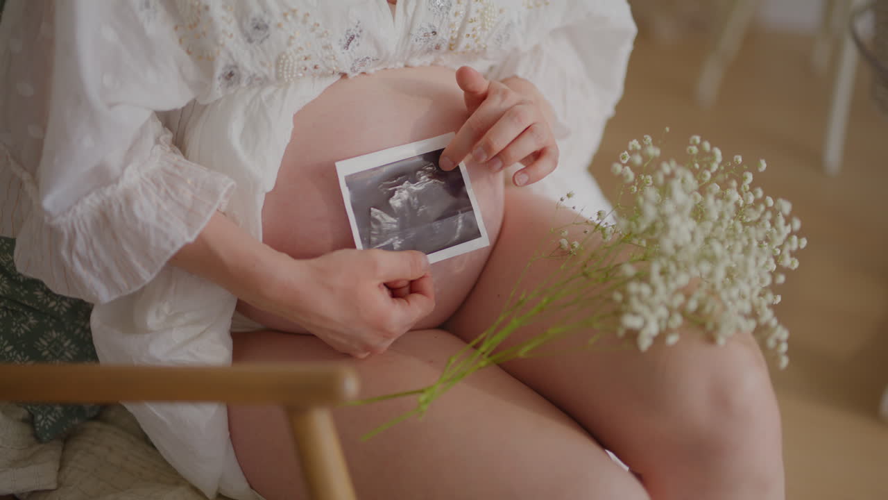 Close-up Ultrasound Newborn on Pregnant Belly