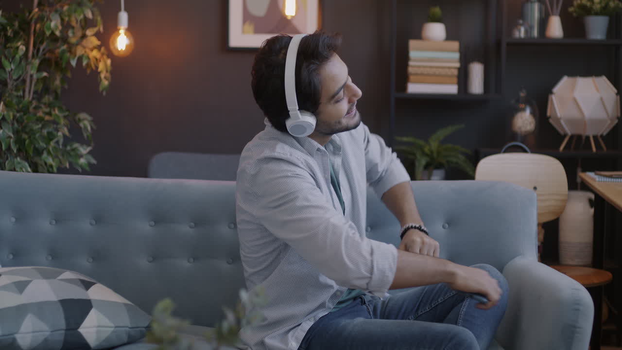 Young Man Listening to Music on Couch