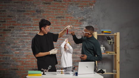 joyful chemist holds tube above girl shooting video for blog