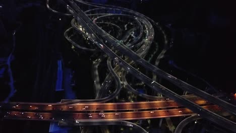 cars travelling at the famous guangzhou interchange at night in guangdong, china.  - high angle shot